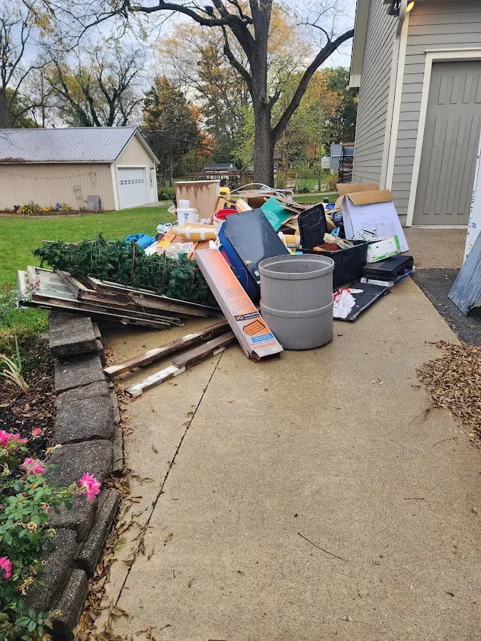 Dumpster being loaded with debris for Estate Cleanout Dumpster Rental in Headland
